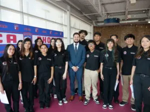 Instructor Marco Patino with graduates of the EMR program