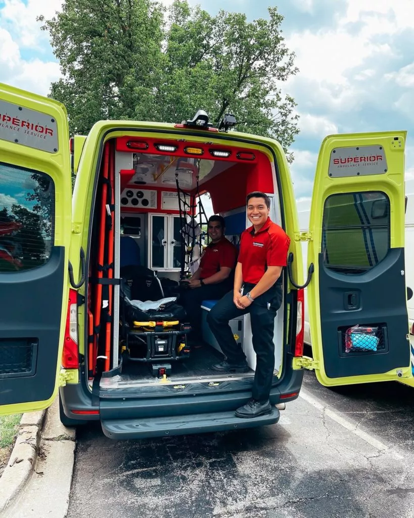 Two Superior Ambulance EMTs smile on emergency ambulance