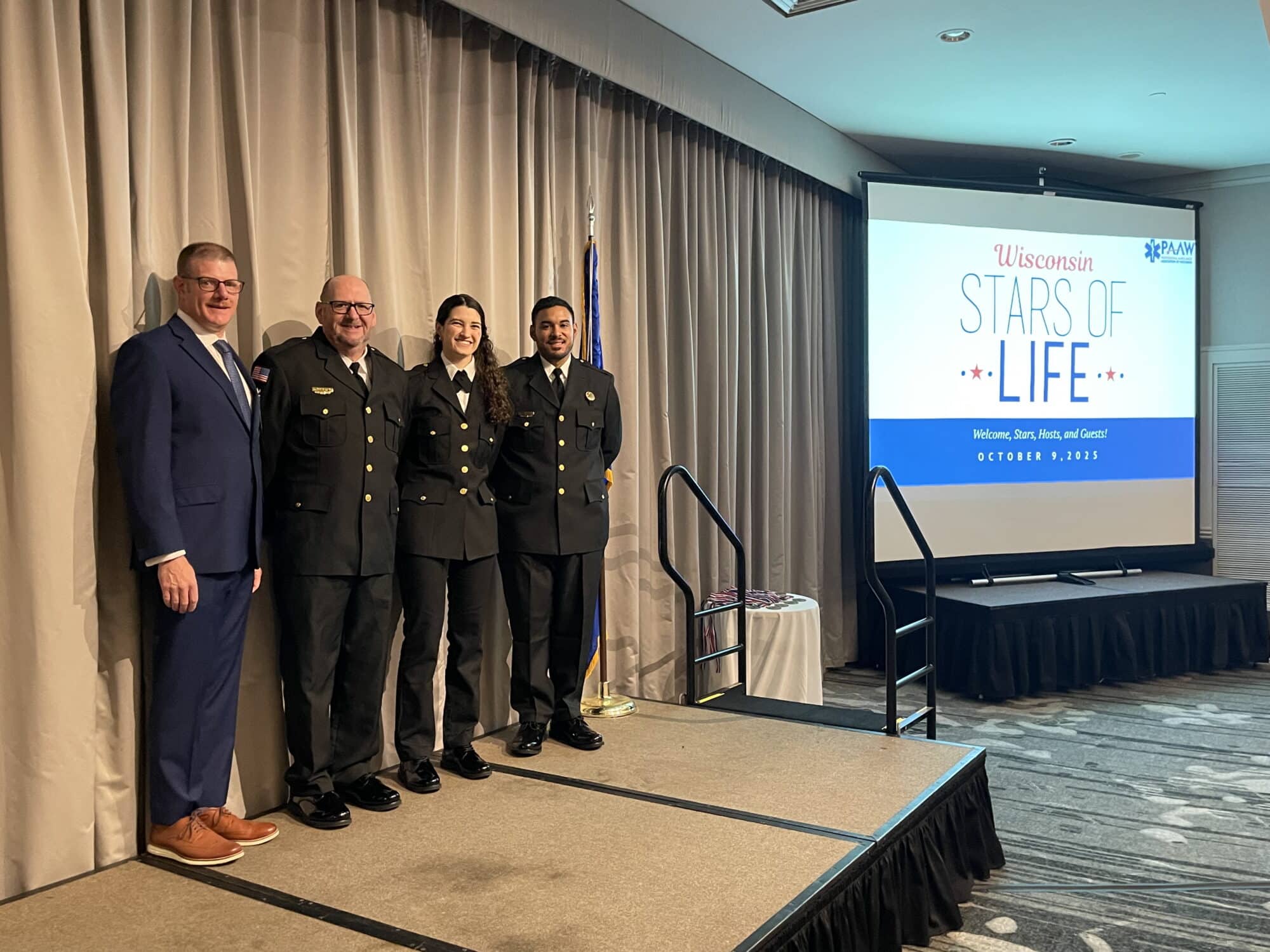 Wisconsin Stars of Life standing on stage with President of PAAW