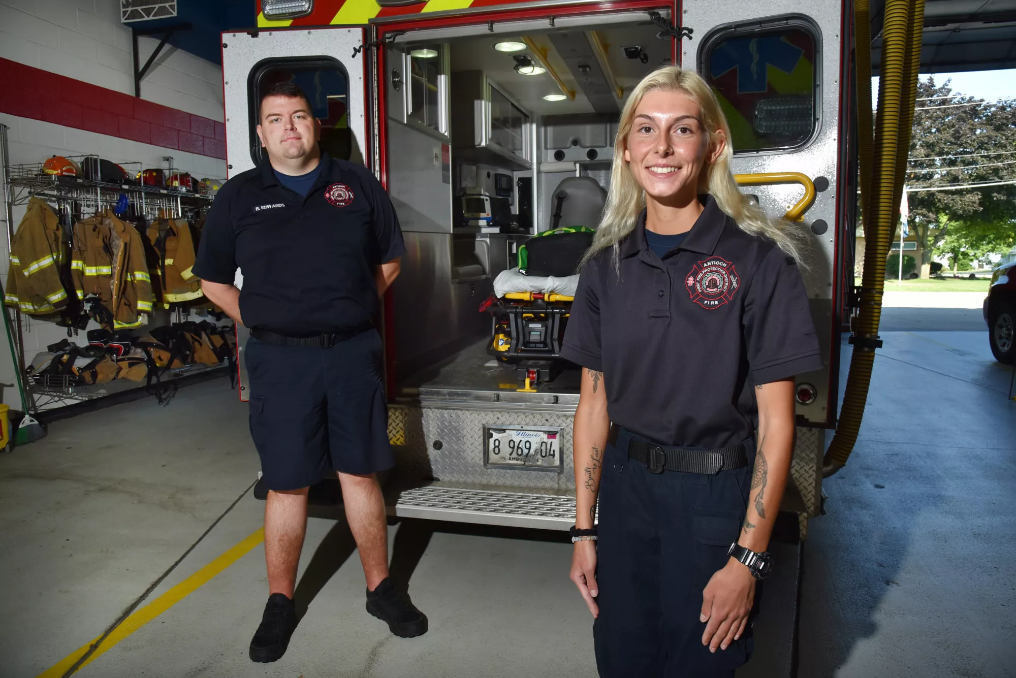 Superior Metro Ambulance Parametics in Antioch, Illinois smile in front of emergency service ambulance