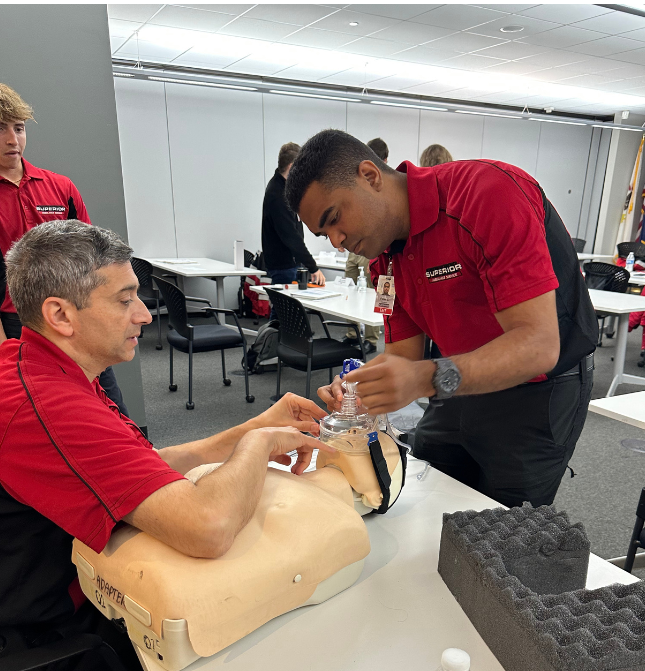 Superior Ambulance Service EMT Class Students Working With CPR Doll
