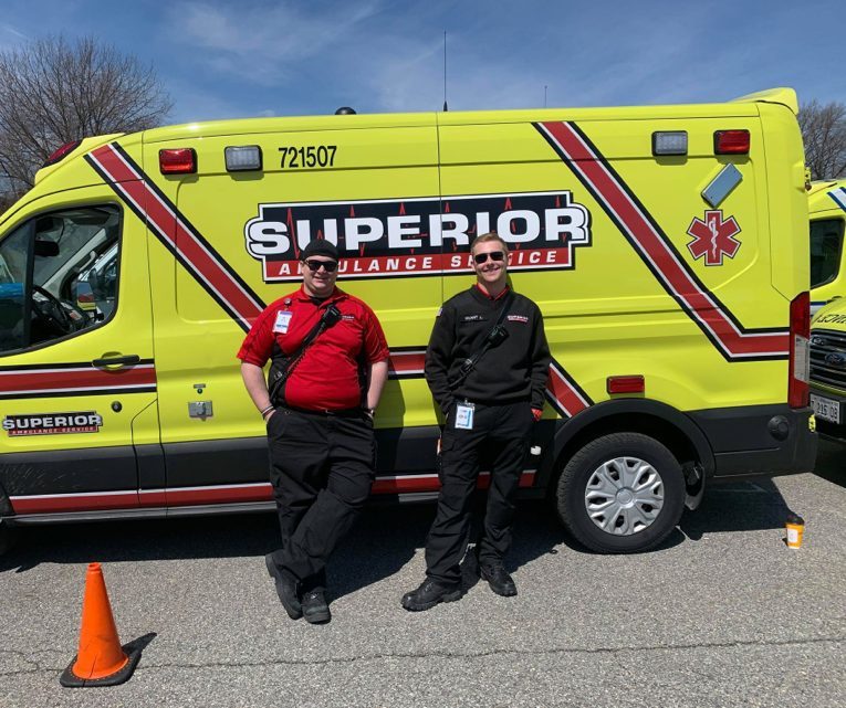 superior ambulance emts standing in front of ambulance