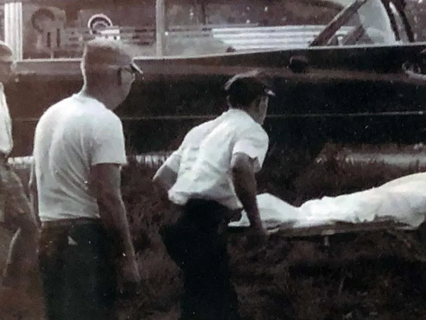 black white photo of emts loading ambulance