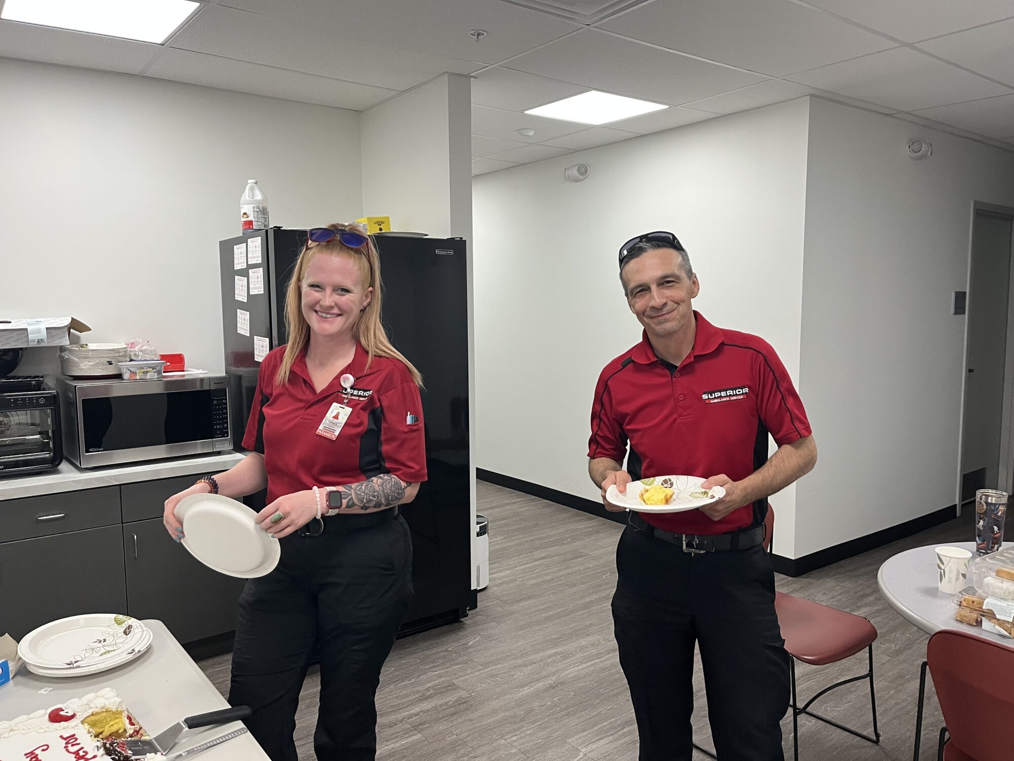 Ohio team eating cake, celebratign Superior's 66th anniversary