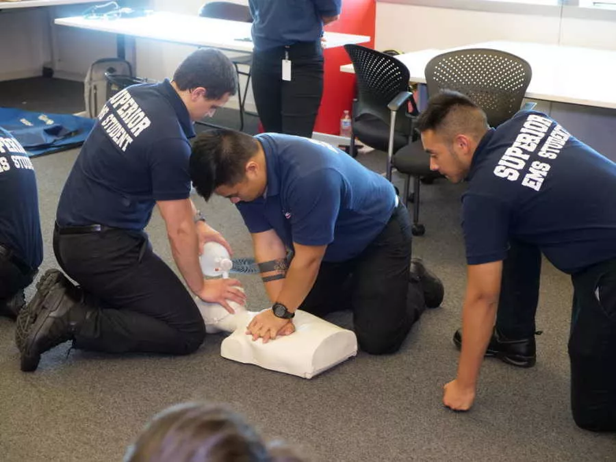 EMT Students Performing CPR on Manikin