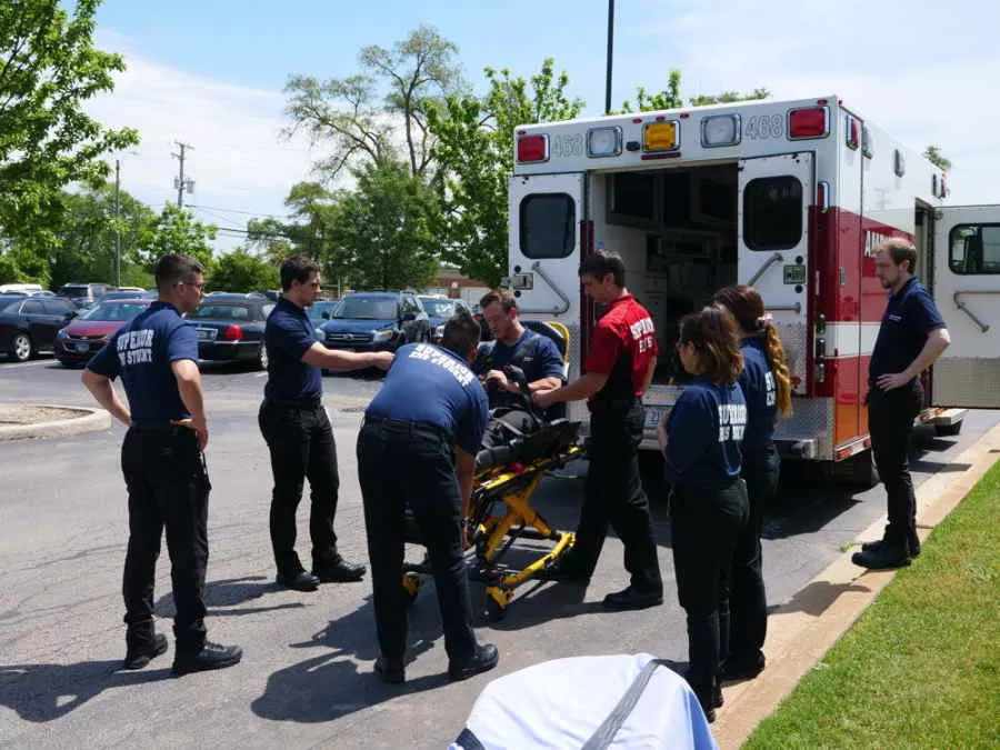 EMT Students Loading Person Into Ambulance