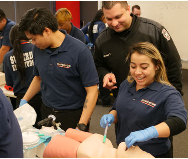 Woman demonstrating emergency medicine on practice dummy