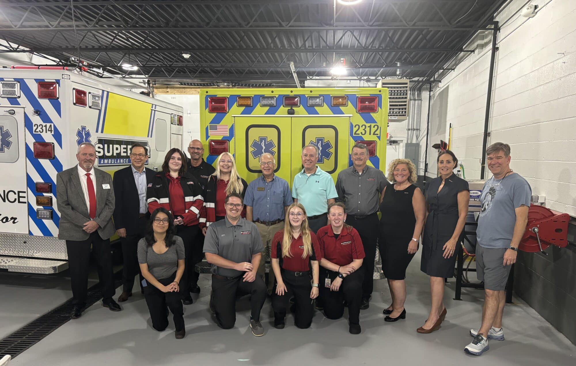Wisconsin employees standing in front of an ambulance
